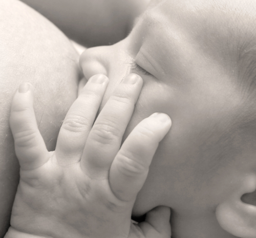 baby near mother's breast